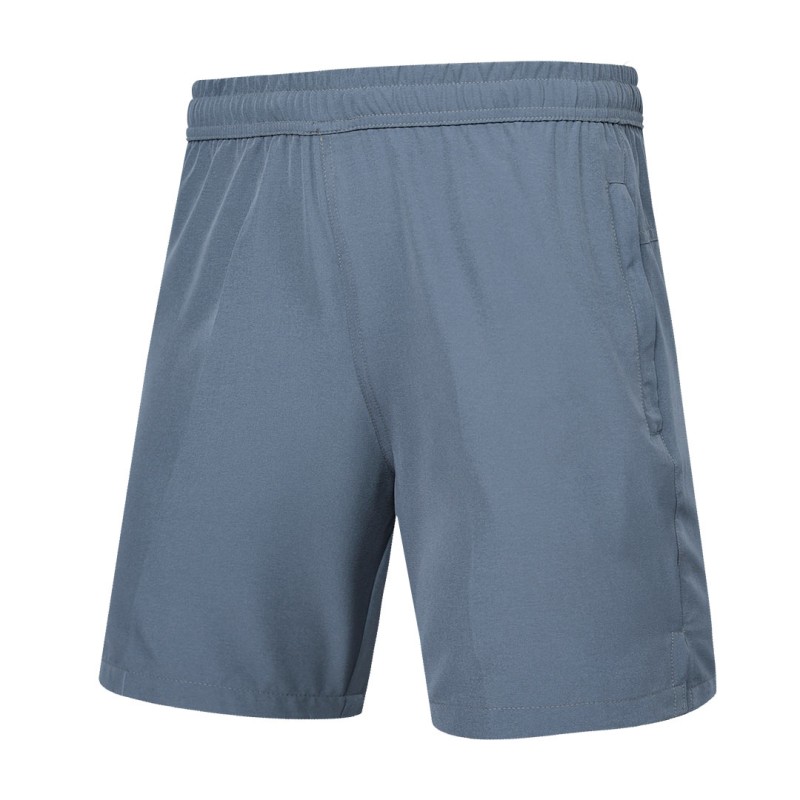 Detail shot of a man wearing comfortable grey-blue KTM CTY Aerfofit half pants, shorts, featuring a secure zip pocket and small side slits at the hem for ease of movement 2