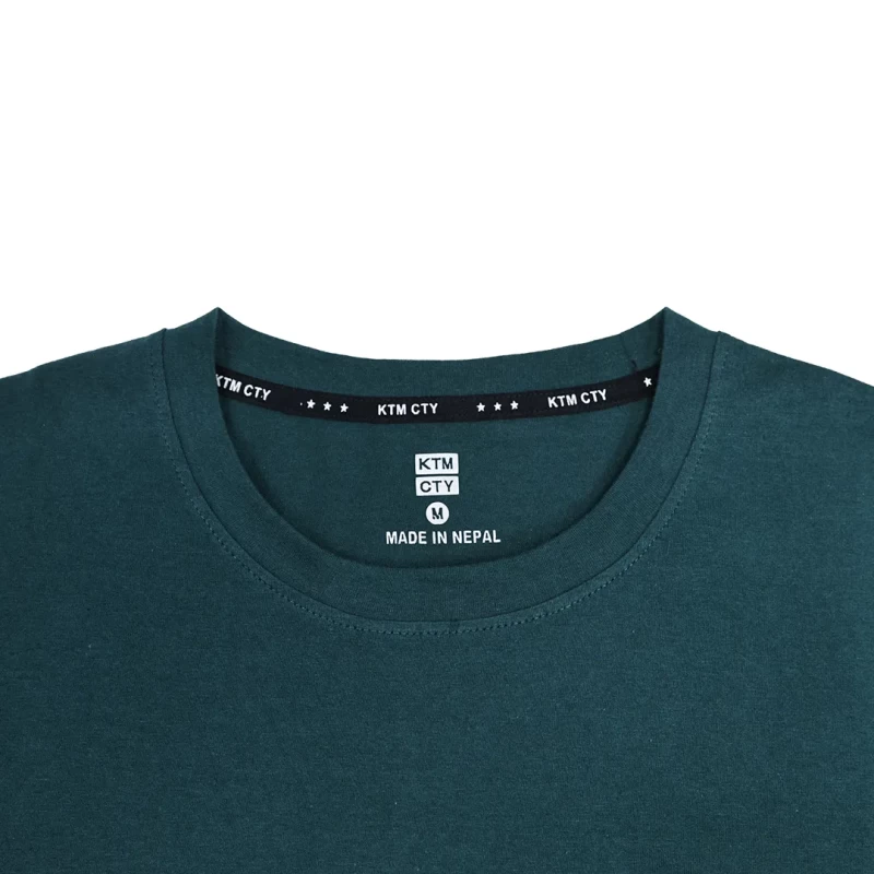 A female model wearing a light grey KTM CTY Core Flex Full Sleeve t-shirt and a male model in the background wearing a dark green version, both styled casually with sunglasses 4