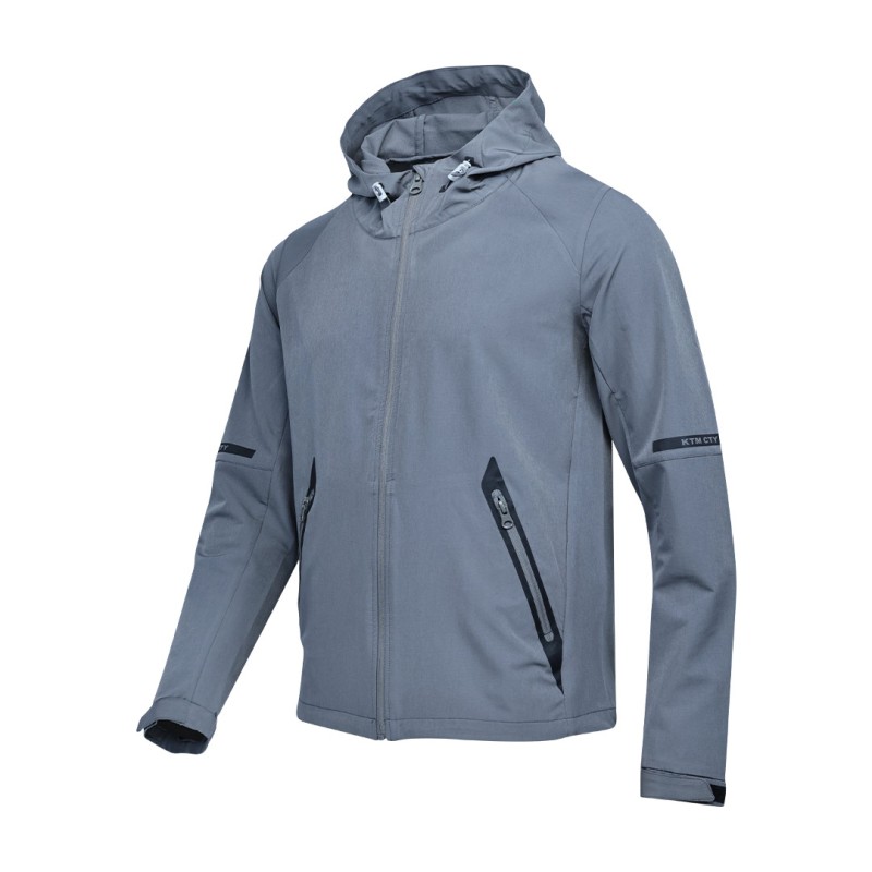 A solid grey KTM CTY Metro Shift Windbreaker jacket featuring a full front zipper, an adjustable hood, and contrasting black zippered side pockets for a sleek, modern look. 0