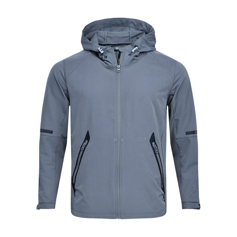 A solid grey KTM CTY Metro Shift Windbreaker jacket featuring a full front zipper, an adjustable hood, and contrasting black zippered side pockets for a sleek, modern look.