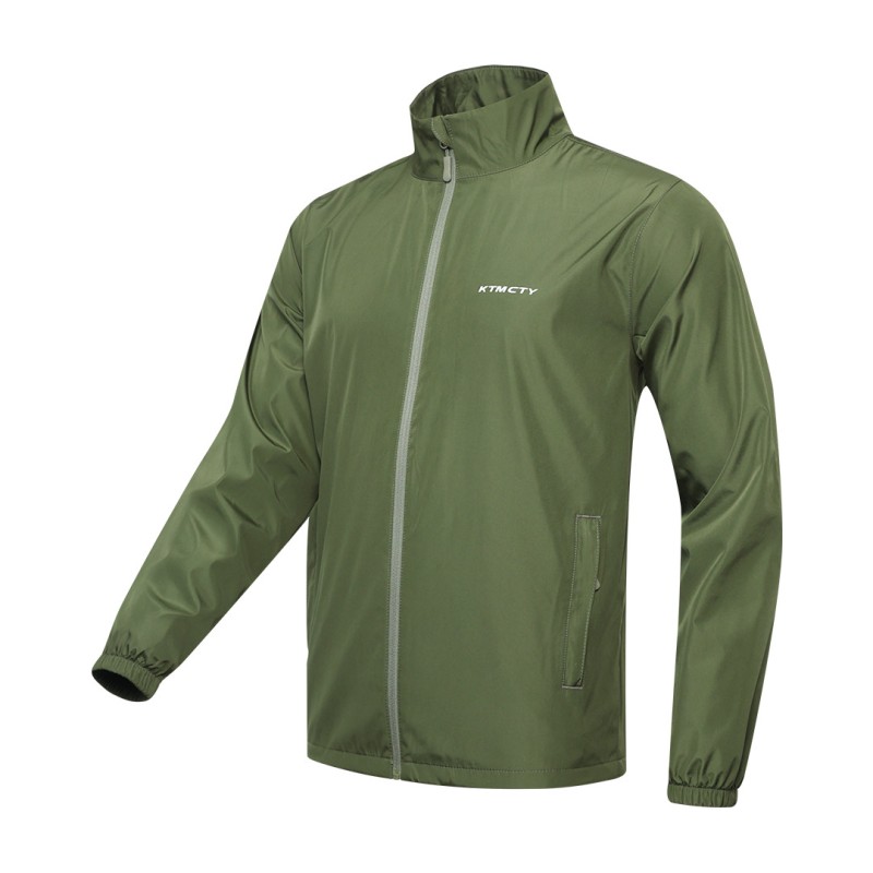 A male model wearing sunglasses looks off to the side while adjusting the collar of his olive green KTM CTY windbreaker, windcheater. The lightweight windguard jacket features a full-zip front, elastic cuffs, and a small white logo on the chest 0