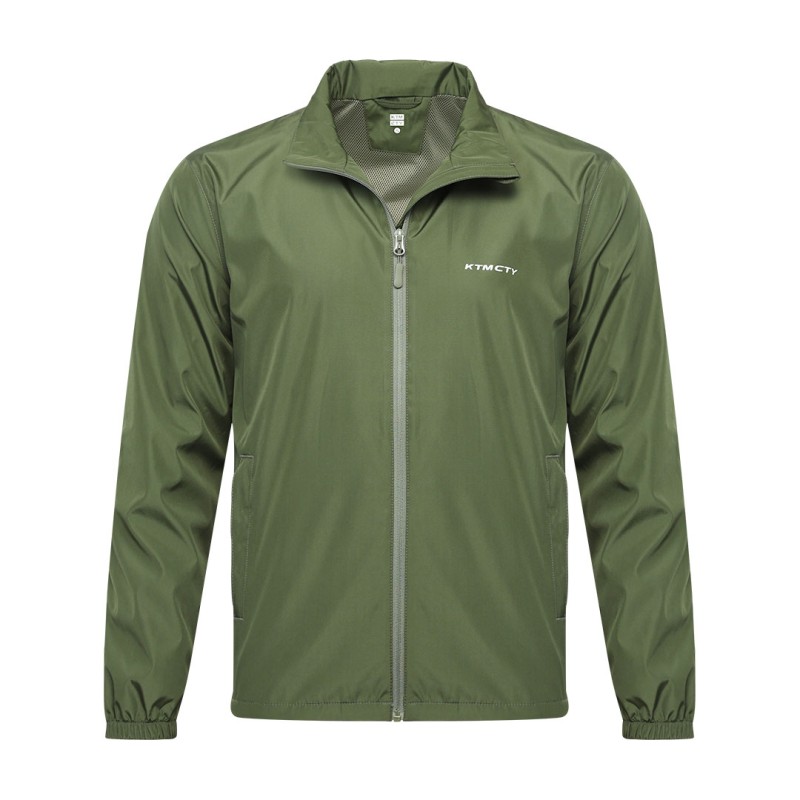 A male model wearing sunglasses looks off to the side while adjusting the collar of his olive green KTM CTY windbreaker, windcheater. The lightweight windguard jacket features a full-zip front, elastic cuffs, and a small white logo on the chest 0