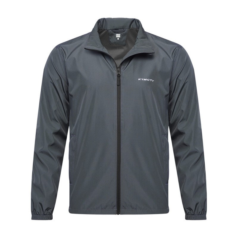 A male model wearing sunglasses looks off to the side while adjusting the collar of his olive green KTM CTY windbreaker, windcheater. The lightweight windguard jacket features a full-zip front, elastic cuffs, and a small white logo on the chest 1