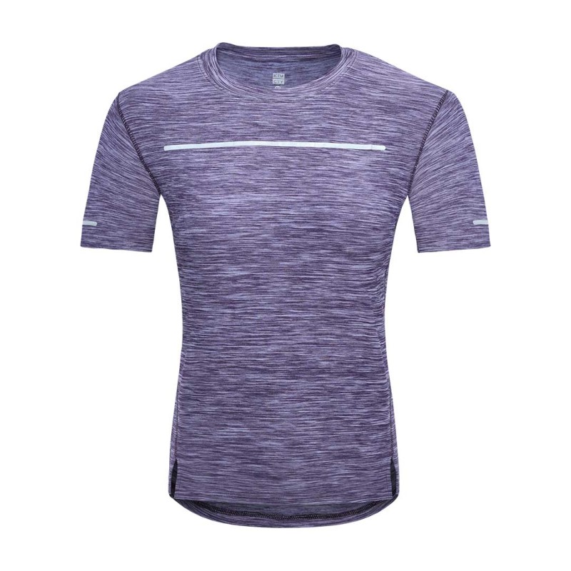 A female model posing with hands on her hips, wearing a purple heathered short-sleeve athletic KTM Luna Wear Crop T-Shirt featuring black horizontal line accents across the chest and sleeves, paired with grey activewear bottoms 0