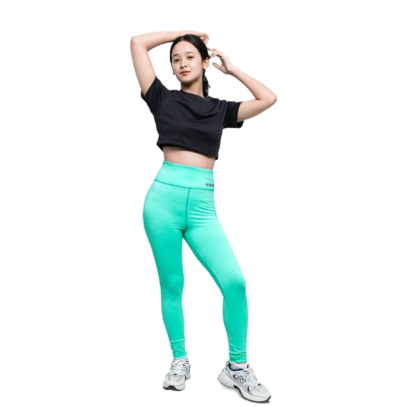 KTM PRO mint green high waisted leggings worn by female model during workout or at gym paired with black crop top and sneakers on white background