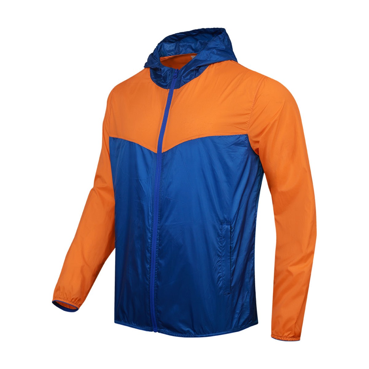 Front view of a male model styling a vibrant red and blue color-block lightweight windcheater jacket. This casual Unisex Windbreaker Jacket features a full zipper and a protective hood, making it a great outer layer for summer wear jacket. 0