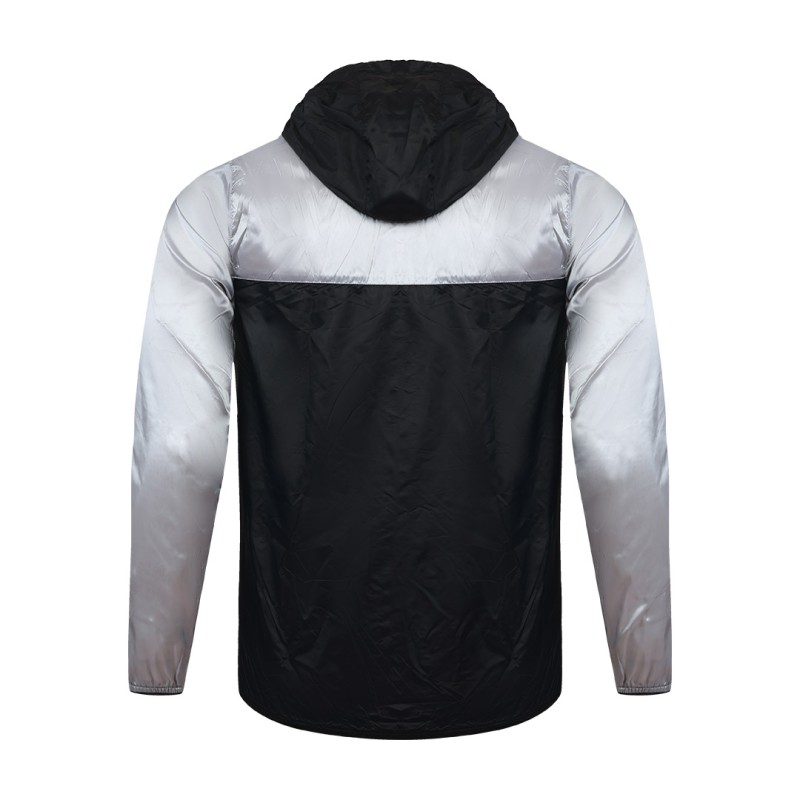 Front view of a male model styling a vibrant red and blue color-block lightweight windcheater jacket. This casual Unisex Windbreaker Jacket features a full zipper and a protective hood, making it a great outer layer for summer wear jacket. 3