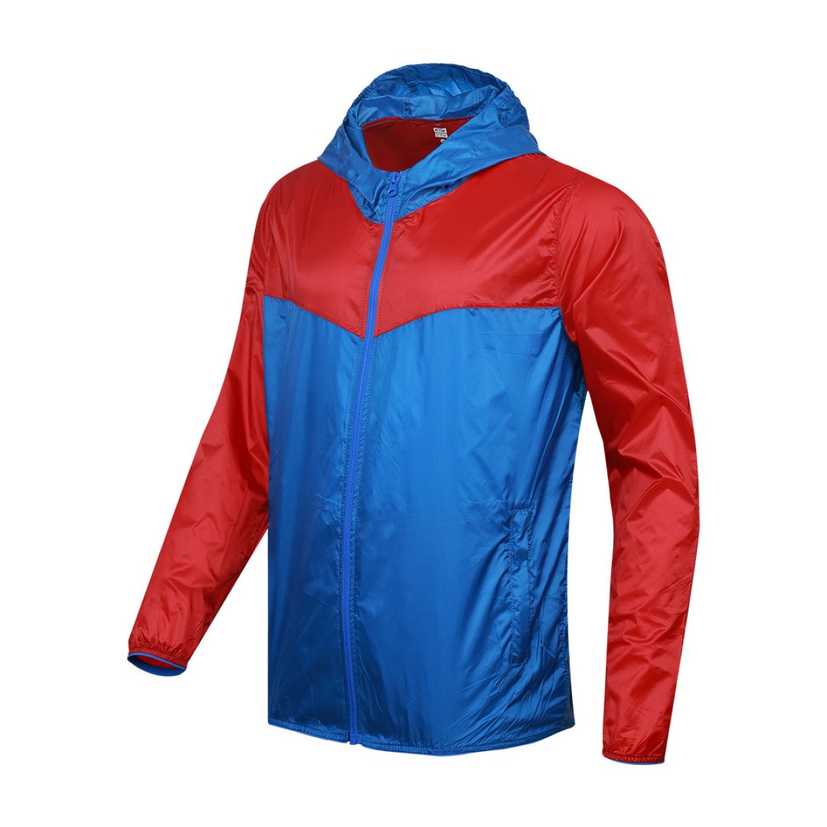 A smiling male model wearing the lightweight SkyShield Windcheater Jacket, featuring a bold red and bright blue color-block design, a full front zipper and an adjustable hood 6