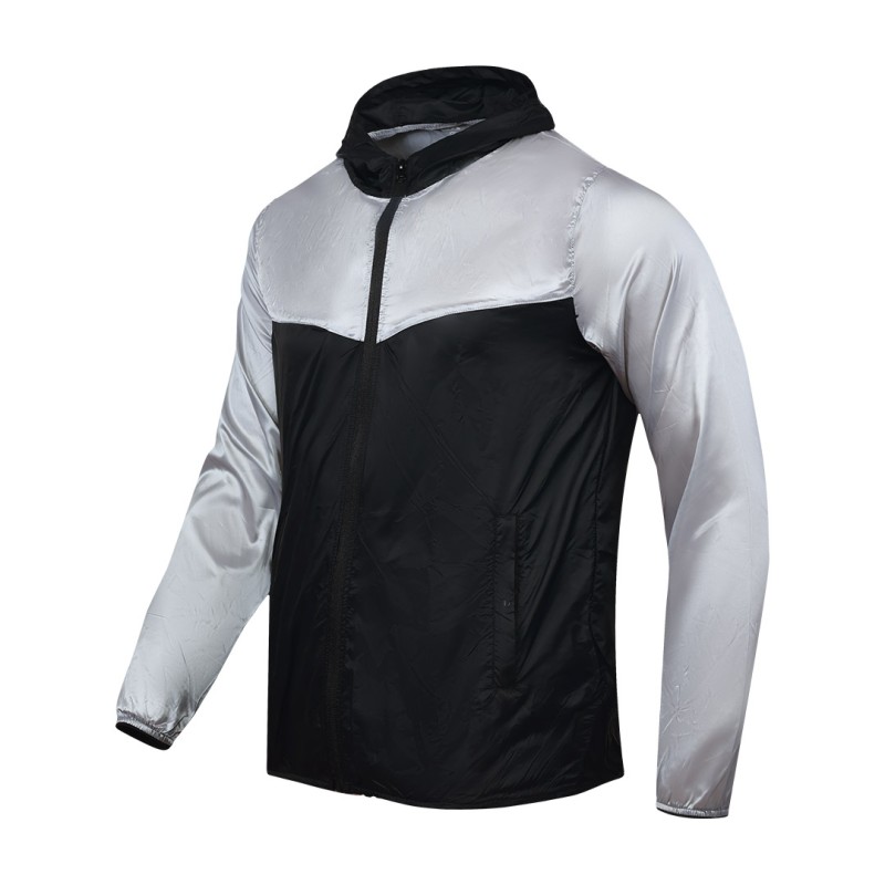 A smiling male model wearing the lightweight SkyShield Windcheater Jacket, featuring a bold red and bright blue color-block design, a full front zipper and an adjustable hood 2