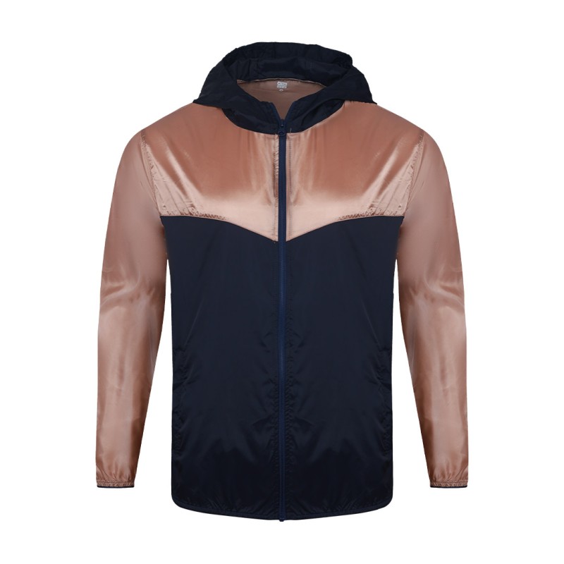 A smiling male model wearing the lightweight SkyShield Windcheater Jacket, featuring a bold red and bright blue color-block design, a full front zipper and an adjustable hood 2