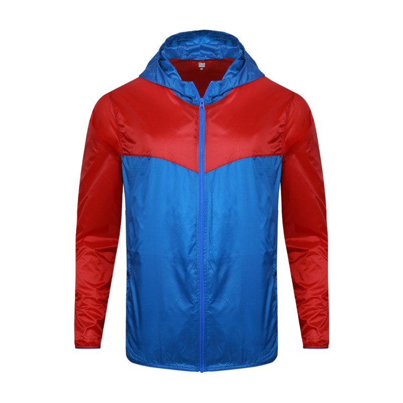 A smiling male model wearing the lightweight SkyShield Windcheater Jacket, featuring a bold red and bright blue color-block design, a full front zipper and an adjustable hood 1