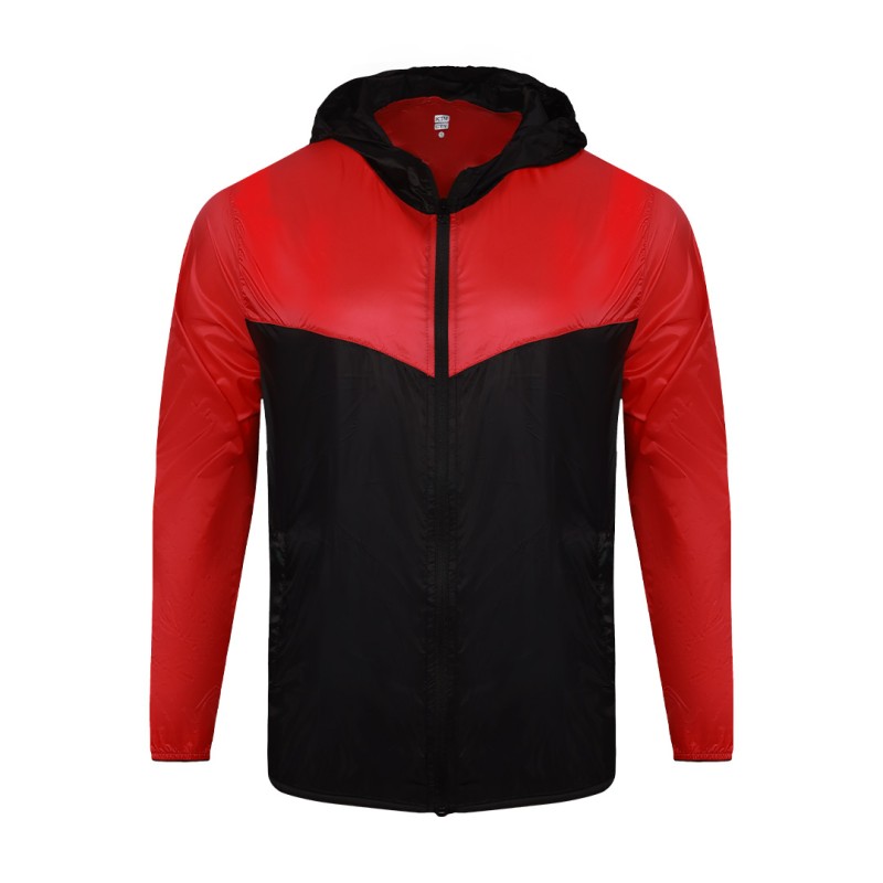 A smiling male model wearing the lightweight SkyShield Windcheater Jacket, featuring a bold red and bright blue color-block design, a full front zipper and an adjustable hood 4