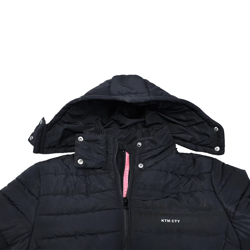 Women's black Stella Quilted Parka Jacket by KTM CTY, side view, showing snap-button adjustable hood, high collar, full front zip, and zippered hip pockets with pull-tabs for her 1