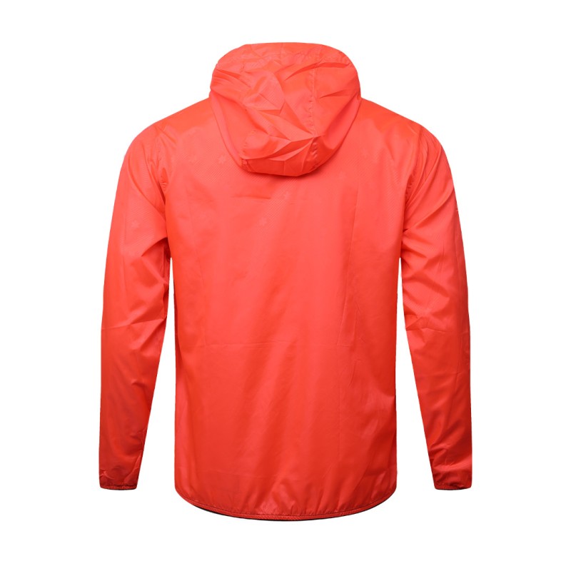 A male model adjusting the zipper of the lightweight, solid red Velocity Breeze Windcheater Jacket with hoodie, featuring a hood and a contrasting black front zipper 7